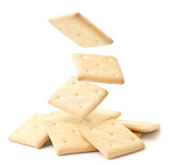 Square crackers fall on a heap on a white background. Isolated