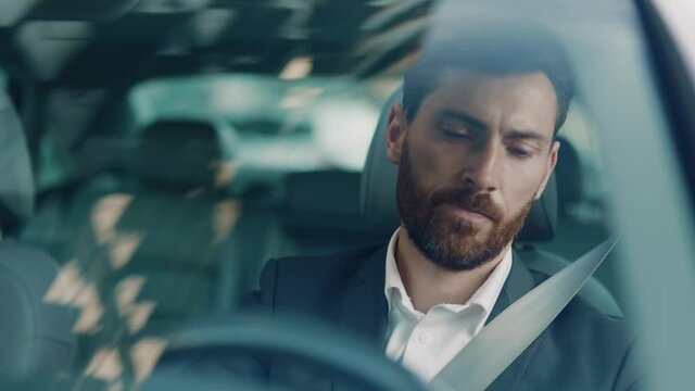 Furious shocked businessman driving car stuck in traffic jam frustrating shouting at drivers. Angry employer late for work waiting on the road. Transport. Emotions concept.