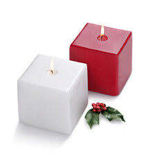 Red and white square burning candles, with holly leaf, isolated on white background