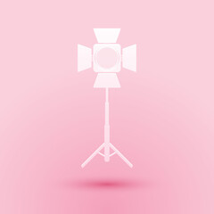 Paper cut Movie spotlight icon isolated on pink background. Light Effect. Scene, Studio, Show. Paper art style. Vector.