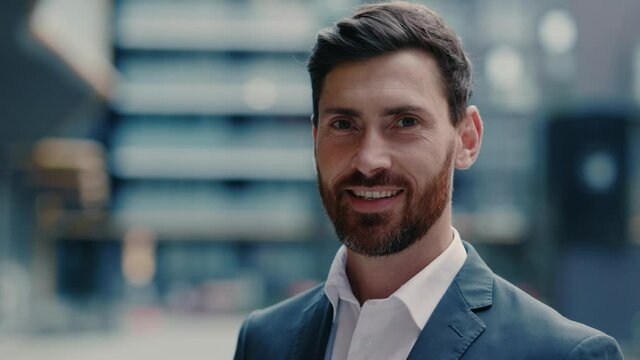 Face of handsome positive businessman corporate leader boss executive successful employer smiling at camera outdoors. Businessperson portrait. Entrepreneur. Expressions.