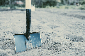 Fototapeta premium metal shovel with a wooden handle in the soil