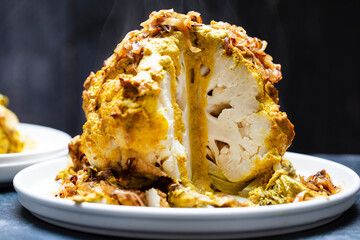 Whole roated cauliflower in curry sauce