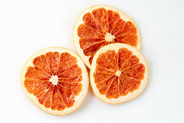 Naklejka na ściany i meble background texture with dried grapefruit citrus slices on a white background