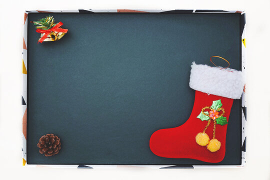 christmas decoration and Red Santa's boot on black background with empty copy space for your text. holiday. new year and christmas postcard or invitation