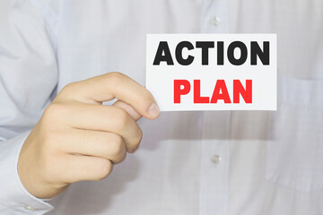 A BUSINESSMAN HOLDS A CARD WITH A WORD IN HIS HAND. a card with a written word AUDIT REPORTS. Light background. selective focus. Business concept