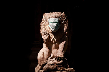 Fototapeta premium Statue of Lion with a Face Mask