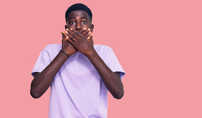 Young african american man wearing casual clothes shocked covering mouth with hands for mistake. secret concept.