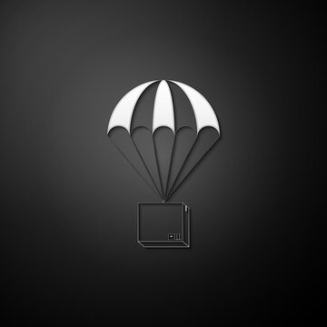 Silver Box flying on parachute icon isolated on black background. Parcel with parachute for shipping. Delivery service, air shipping concept, bonus. Long shadow style. Vector.