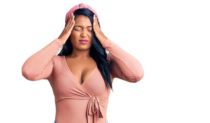 Hispanic woman with long hair wearing casual clothes suffering from headache desperate and stressed because pain and migraine. hands on head.