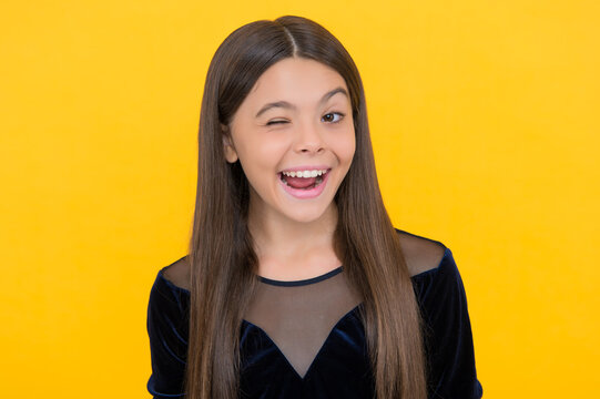 Happy Little Girl Child Smile Winking With Open Mouth And Showing Healthy Teeth Yellow Background, Dentistry