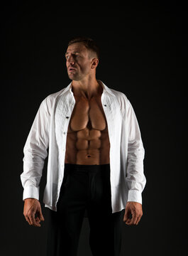 Strong and elegant. Muscular man black background. Formal style. Fashion wardrobe. Trendy menswear. Dress code. Handsome man show six pack abs in open shirt. Wellness and bodycare. Sport and health
