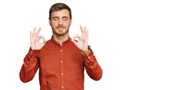 Handsome caucasian man wearing casual clothes relax and smiling with eyes closed doing meditation gesture with fingers. yoga concept.