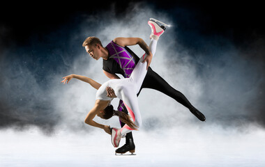 Fototapeta na wymiar Duo figure skating in action on dark background. Sports banner