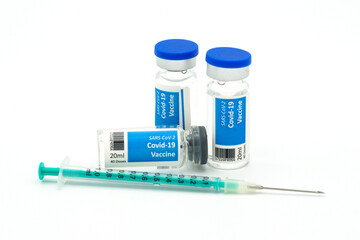 Covid-19 vaccination vials and a syringe with needle