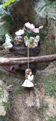 Interior of abandoned garden with angel statue with mossy green leaves