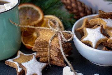 Cute Christmas or New Year composition with cookies, mug of coffee and dried orange