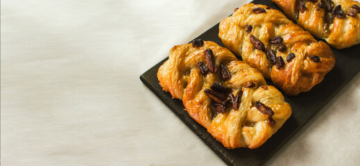 Danish pastry maple pecan with nuts and maple syrup.Space for text. banner.