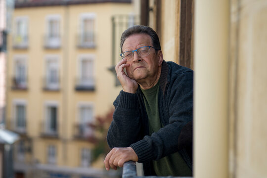 Lifestyle Portrait Of Sad And Depressed Mature Man 65 To 70 Years Old At Home Balcony Feeling Lonely And Confused Facing Getting Old And Retirement Alone Looking Away Thoughtful