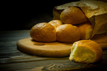 fresh buns in a paper bag lying on the table