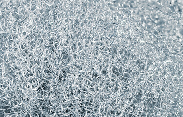 Heap of spiral twisted metal chips of alu alloy in silver-blue toned background. Abstract texture...