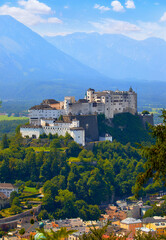 Fototapeta na wymiar Fortress Salzburg in Austria medieval castle at cliff under the old town. Famous landmark with summer sky with clouds.