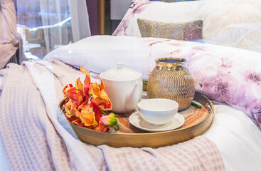 Tray with teapot and Cup on the bed