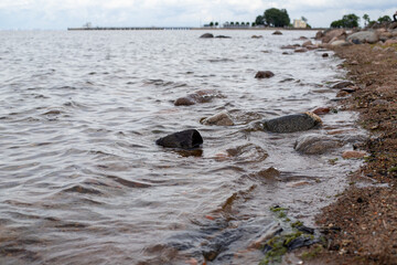 stones on the river bank and small waves