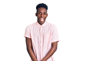 Young african american man wearing casual clothes sticking tongue out happy with funny expression. emotion concept.