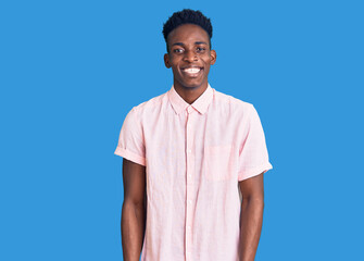 Young african american man wearing casual clothes winking looking at the camera with sexy...