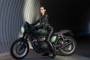 Naklejka na ściany i meble woman in black with a motorcycle