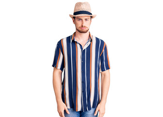 Young handsome caucasian man wearing summer hat depressed and worry for distress, crying angry and afraid. sad expression.