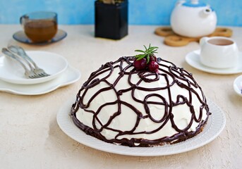 Dessert, homemade cake with chocolate biscuit, cherry and cream of sour cream and whipped cream on a white plate