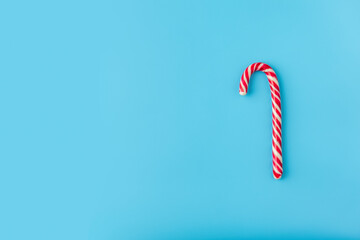 Christmas candy y on blue background. Candy shapes, candy cane. Flat lay, top view. Copy space