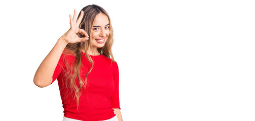 Obraz na płótnie Canvas Young beautiful blonde woman wearing casual clothes smiling positive doing ok sign with hand and fingers. successful expression.