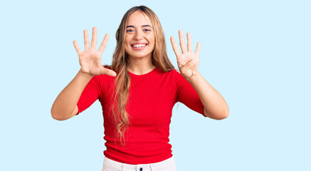 Young beautiful blonde woman wearing casual clothes showing and pointing up with fingers number nine while smiling confident and happy.