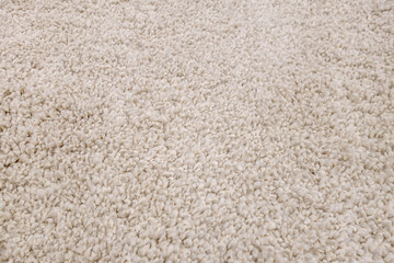 abstract background of warm artificial beige fur on a knitted base close up