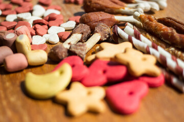 Dog tasty colored biscuits on wooden background 
