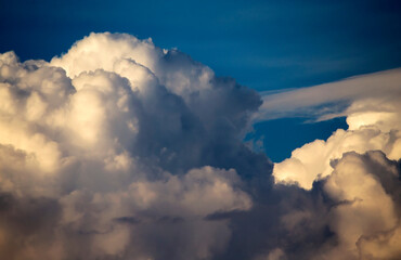 Cumulus clouds in the sunset light. Abstract composition of dramatic sky.