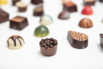 lot of variety chocolate pralines, top view of various chocolate pralines isolated on white background