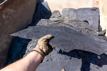 Waste roofing felt in container. Recycling, garbage.