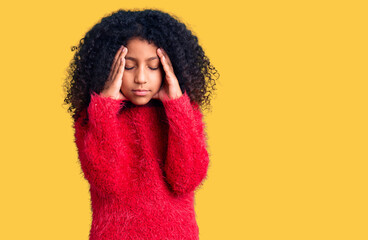African american child with curly hair wearing casual winter sweater suffering from headache...