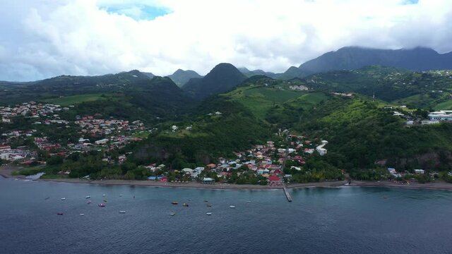 le Carbet aerial view Martinique beachfront houses and restaurants and Pitons mountains in background