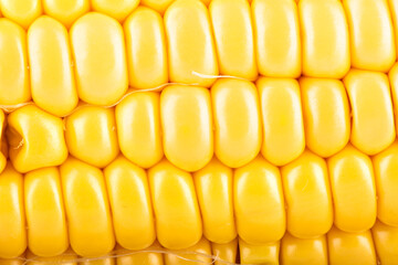 Close-up shot of a peeled ripe corncob.