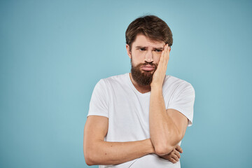 Man in white t-shirt emotions facial expression cropped view studio blue background lifestyle