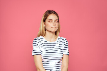 Obraz premium Woman in striped t-shirt emotions studio cropped view lifestyle pink isolated background