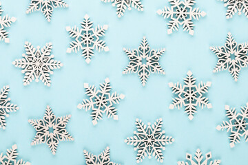 Christmas background. White snow decorations on a pink background.