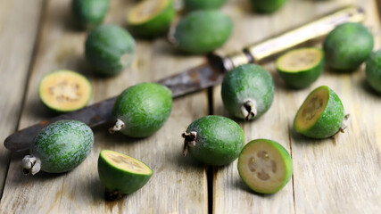 Feijoa fruits on a wooden surface. Feijoa halves.