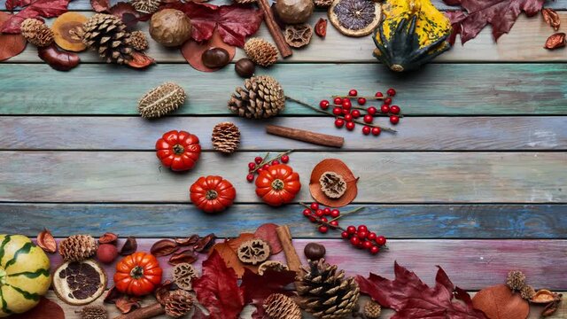 Fall background on wooden table with colorful vegetables, pumpkins, autumn harvest, leaves with copy space. Loop stop motion, timelapse