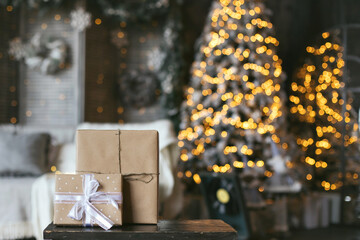 Christmas gifts festive background. Present in craft packaging paper zero waste. New year mood. Texture place for text banner. Cozy hugge comfort home. Bokeh blur
